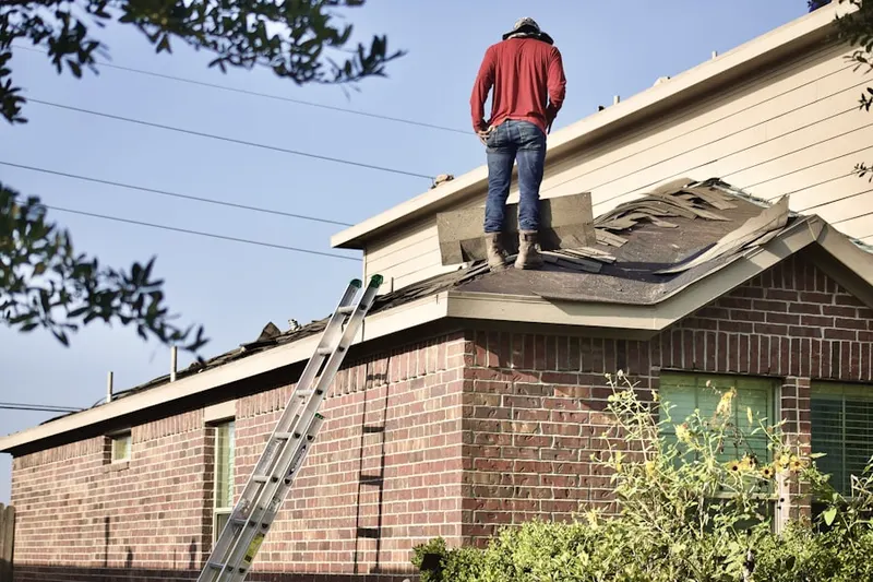Professional roofer working on a residential roof in Rose Hill Farms